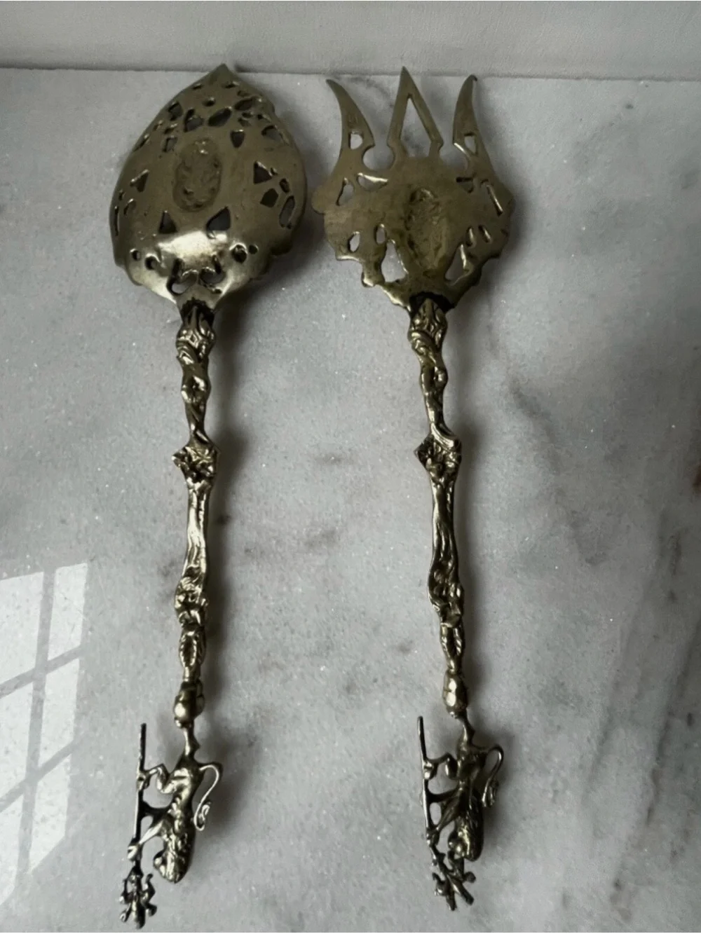vintage Italian serving utensils are an ornate brass fork and spoon set